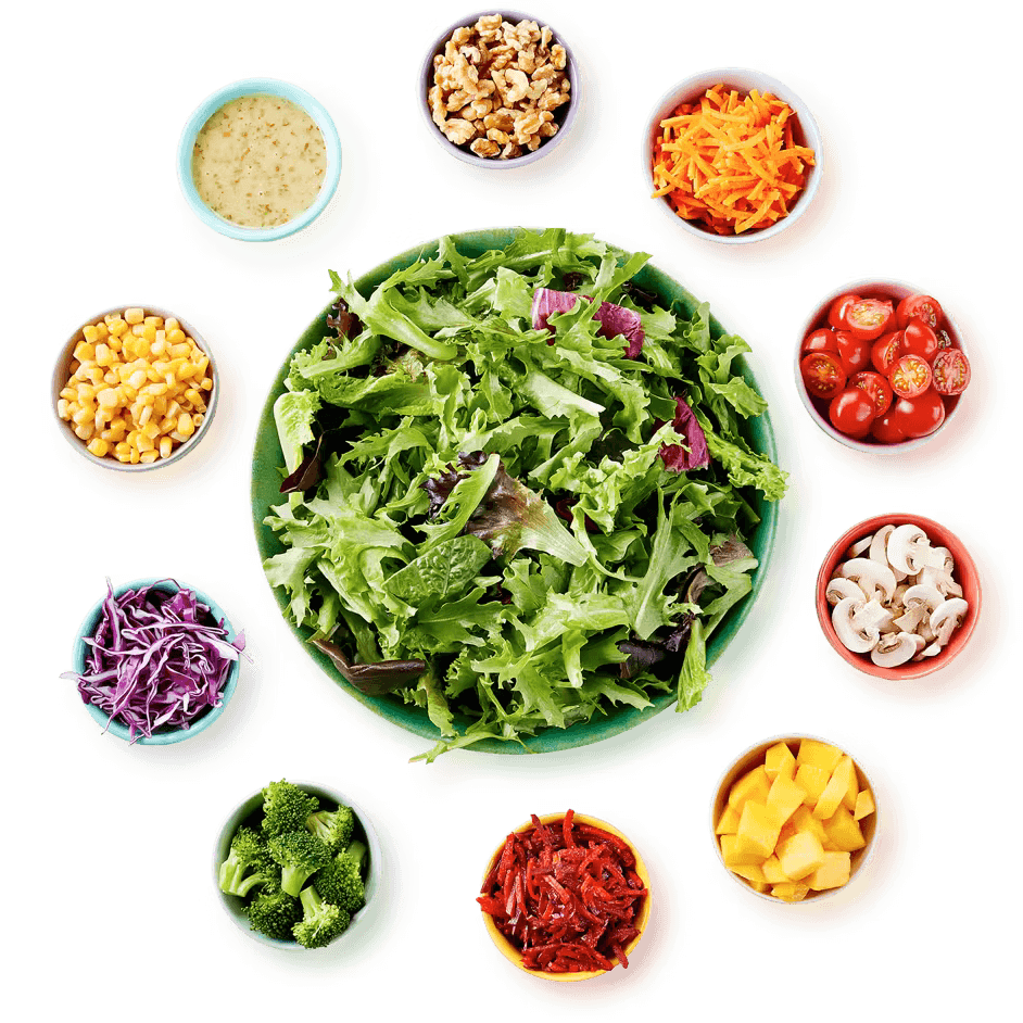Salad surrounded by different healthy ingredients like a salad bar